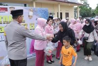 Kapolres Tanah Bumbu AKBP Arief Prasetya bersama jajaran dan Bhayangkari saat membagikan paket takjil kepada pengguna jalan di depan Mako Polres Tanah Bumbu, Kamis (12/3/2026) sore.